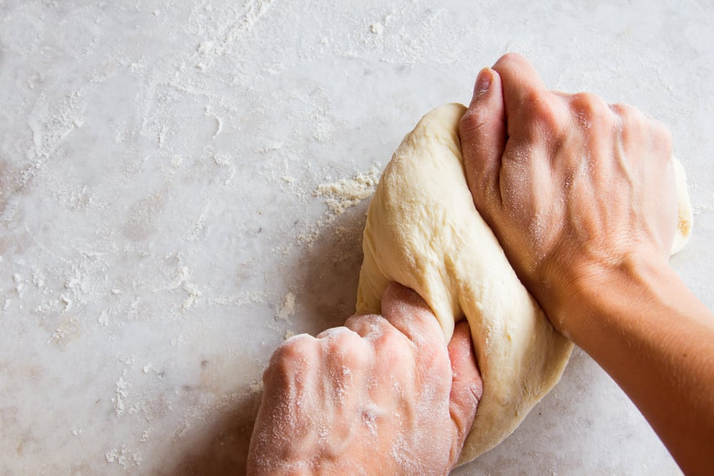 Hands kneading dough