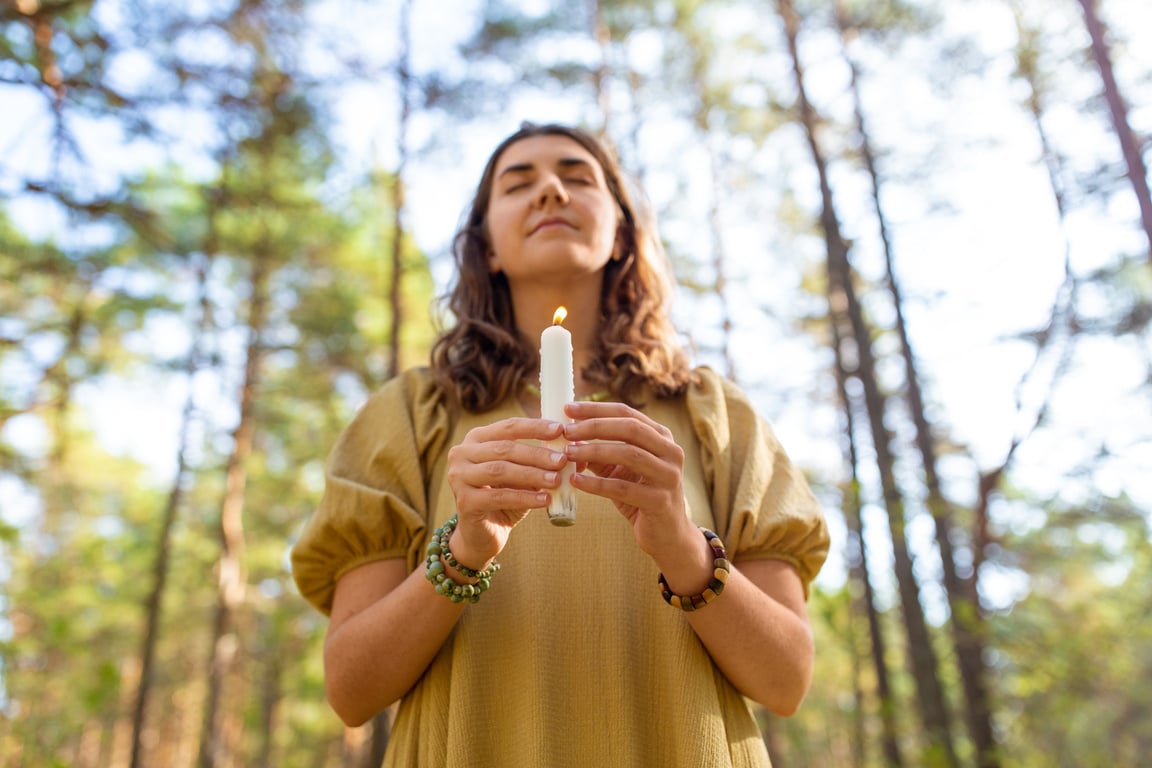 Woman with Candle Performing Magic Ritual